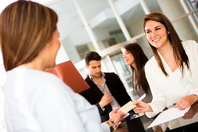 Woman doing check-in at a hotel and paying by credit cad.jpeg